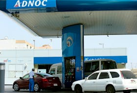 A worker injects a car with fuel at an ADNOC petrol station in Abu Dhabi, United Arab Emirates July 10, 2017.