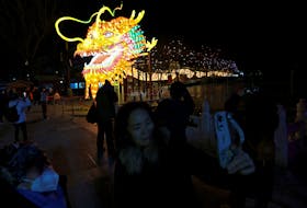 People take pictures of a dragon installation ahead of the Lunar New Year in Beijing, China, February 7, 2024.