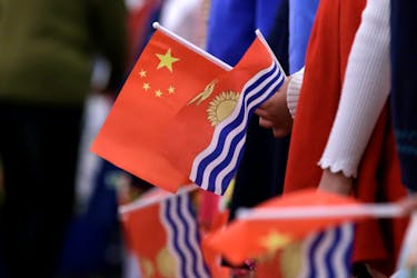 Students holding national flags of China and Kiribati wait for a welcoming ceremony  for Kiribati's President Taneti Maamau at the Great Hall of the People in Beijing, China January 6, 2020.
