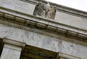 An eagle tops the U.S. Federal Reserve building's facade in Washington, July 31, 2013.