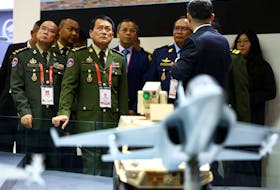 Cambodia's Armed Forces Commander-in-chief Vong Pisen tours the Aviation Industry Corporation of China (AVIC) booth during the Singapore Airshow at Changi Exhibition Centre in Singapore, February 20, 2024.