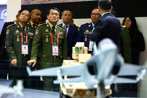 Cambodia's Armed Forces Commander-in-chief Vong Pisen tours the Aviation Industry Corporation of China (AVIC) booth during the Singapore Airshow at Changi Exhibition Centre in Singapore, February 20, 2024.