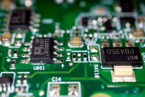 Semiconductor chips are seen on a printed circuit board in this illustration picture taken February 17, 2023.