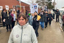 Theresa Gray, Devon Marsman's mom, takes part in a protest in front of Halifax Regional Police headquarters on Friday afternoon. There were more than 50 people participating.