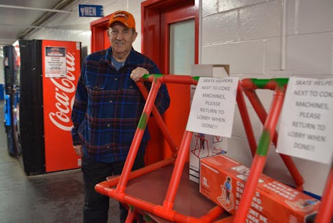 Mickey McNeil stands beside some of the skating aids that community members donated to buy to have at the Dominion District Community Centre. NICOLE SULLIVAN/CAPE BRETON POST