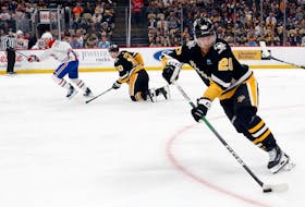 Feb 22, 2024; Pittsburgh, Pennsylvania, USA; Pittsburgh Penguins center Lars Eller (20) skates to clear the puck  the Montreal Canadiens during the second period at PPG Paints Arena. The Penguins won 4-1. / Charles LeClaire-USA TODAY Sports