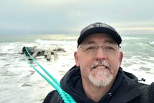 Shawn Bath of the Clean Harbours Initiative smiles after successfully tying new ropes to the shipwreck on the beach at Cape Ray in southwestern Newfoundland on Friday, Feb. 23, 2024. - Clean Harbours Initiative