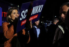 Republican presidential candidate and former U.S. Ambassador to the United Nations Nikki Haley autographs a campaign sign for an audience member at a campaign stop in Myrtle Beach, South Carolina, U.S., February 22, 2024.