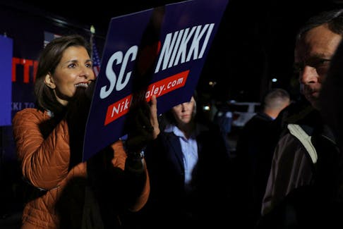 Republican presidential candidate and former U.S. Ambassador to the United Nations Nikki Haley autographs a campaign sign for an audience member at a campaign stop in Myrtle Beach, South Carolina, U.S., February 22, 2024.