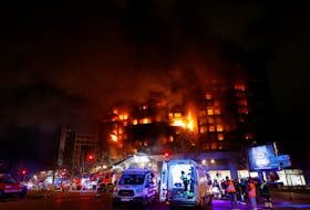 Emergency services work at the scene of a fire of apartment building in Valencia, Spain February 22, 2024.