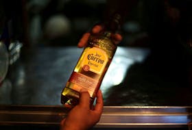 A man receives a bottle of Jose Cuervo Tequila in Mexico City, Mexico, February 8, 2017. 