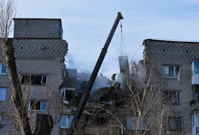 A rescue worker operates at the site of an apartment building damaged by a Russian drone strike, amid Russia's attack on Ukraine, in Dnipro, Ukraine February 23, 2024.