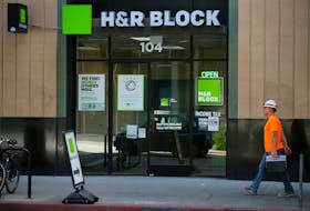 A construction worker walks past a H&R Block tax office in Los Angeles, California, U.S., April 26, 2017. 