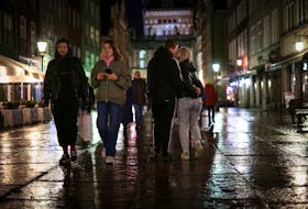 Dariia Vynohradova, 17, from Kharkiv, kisses her boyfriend Dmytro Demchevskyi, 18, from Yuzhnoukrainsk, during an evening walk in the Old Town in Gdansk, Poland, February 21, 2024. Vynohradova left her parents behind in Ukraine and said she no longer wanted to go back. "I don't want to go back because Kharkiv is destroyed so much, there is nothing to go back to. I will go back to visit my parents sometimes, but I want to stay here."       