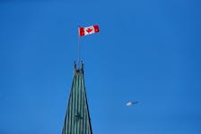 Royal Canadian Mounted Police (RCMP) helicopter flies past the Peace Tower on Parliament Hill, during the visit of U.S. President Joe Biden, in Ottawa, Ontario, Canada March 24, 2023.
