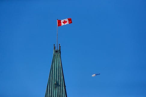 Royal Canadian Mounted Police (RCMP) helicopter flies past the Peace Tower on Parliament Hill, during the visit of U.S. President Joe Biden, in Ottawa, Ontario, Canada March 24, 2023.
