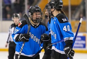 Toronto's Emma Maltais (27) celebrates her goal with teammate Blayre Turnbull (40) during third period PWHL action against New York in Toronto, Friday, Feb. 23, 2024.