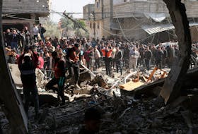 Palestinians gather at the site of an Israeli strike on a house, amid the ongoing conflict between Israel and Hamas, in Rafah, in the southern Gaza Strip February 24, 2024.