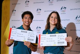 Rachael Gunn and Jeff Dunne, Australia's first Olympic breakers pose with their plane tickets after they are announced as representatives ahead of the 2024 Paris Summer Olympics, at Redfern Community Centre in Sydney, Australia, February 24, 2024.
