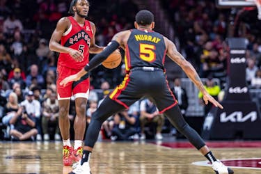 Toronto Raptors guard Immanuel Quickley (5) brings the ball down court during while being guarded by Atlanta Hawks guard Dejounte Murray (5) the first half of an NBA basketball game, Friday, Feb. 23, 2024, in Atlanta.