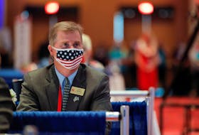 Mississippi's national committeeman to the Republican National Committee Henry Barbour attends U.S. President Donald Trump's speech wearing a red, white and blue Amerian flag protective face mask because of the coronavirus disease (COVID-19) pandemic on  the first day of the 2020 Republican National Convention in Charlotte, North Carolina, U.S., August 24, 2020.