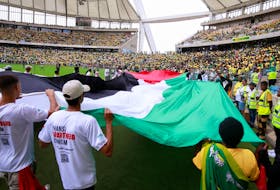 Supporters display a giant Palestinian flag at the African National Congress Election Manifesto launch in Durban, South Africa, February 24, 2024.