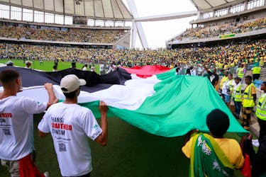 Supporters display a giant Palestinian flag at the African National Congress Election Manifesto launch in Durban, South Africa, February 24, 2024.