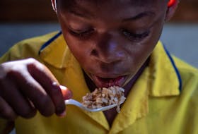 Anderson, 9, eats a serving of beans and rice during a lunch break at the St Mary School of the Famille Kizito located in Cite Soleil, Port-au-Prince, Haiti November 5, 2021.
