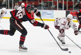 UNB Reds forward Isaac Nurse fires a shot toward the Saint Mary's Huskies' goal during Game 2 action of their best-of-five semifinal Saturday night in Fredericton. - UNB Athletics