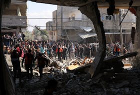 Palestinians gather at the site of an Israeli strike on a house, amid the ongoing conflict between Israel and Hamas, in Rafah, in the southern Gaza Strip February 24, 2024.