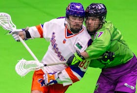 Randy Staats of the Halifax Thunderbirds battles with the Saskatchewan Rush's Ryan Barnable during National Lacrosse League action in Saskatoon on Saturday night. - National Lacrosse League