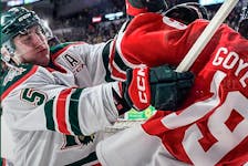 Halifax Mooseheads defenceman Brady Schultz lays a hit on Quebec Remparts winger Loic Goyette during Sunday's QMJHL game in Quebec City. - Contributed