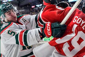 Halifax Mooseheads defenceman Brady Schultz lays a hit on Quebec Remparts winger Loic Goyette during Sunday's QMJHL game in Quebec City. - Contributed