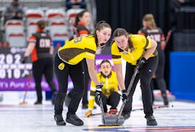 Lead Lauren Lenentine, right, of Cornwall, P.E.I., and third stone Karlee Burgess, left, sweep a rock during play at the Scotties Tournament of Hearts in Calgary. Lenentine and Burgess play with the Jennifer Jones rink, which has advanced to the final day of play in the Canadian women’s curling championship on Feb. 25. Curling Canada / Andrew Klaver