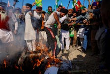 Farmers shout slogans as they burn an effigy of Prime Minister Narendra Modi and other ministers at a protest site, during the march towards New Delhi to push for better crop prices promised to them in 2021, at Shambhu Barrier, the border between Punjab and Haryana states, India February 23, 2024.