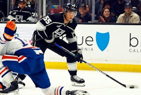 Los Angeles Kings forward Quinton Byfield makes a pass against Mattias Ekholm of the Edmonton Oilers in the second period at Crypto.com Arena on February 10, 2024 in Los Angeles, California.