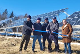 Jesse Mitham, second from right, prepares to cut the blue ribbon with Bruce Mitham of Rothiemay Farms, second from left, as well as The Smart Energy Company's CEO Mark McAloon, centre, Jeff McAloon, chief development officer, left, and Saint John-Rothesay MP Wayne Long, right. The Quispamsis-based firm opened its micro solar farm kit at the Norton farm.