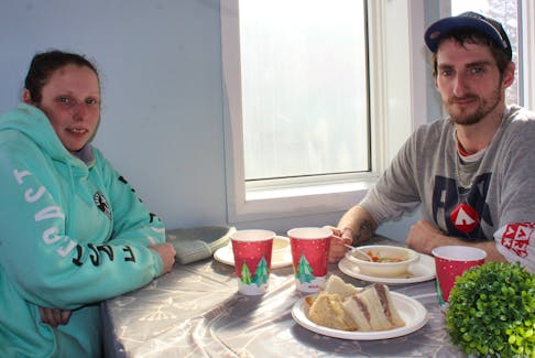 Morgan Walsh, left, and Greg Gerrow take in a warm meal at the Souls Harbour Rescue Mission drop-in centre on Monday in Sydney Mines. The mission's first Cape Breton location officially opened on Monday at 848 Main St. IAN NATHANSON/CAPE BRETON POST