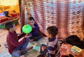 Palestinian brothers of the Shehada family, who lost their mother and another brother, and fled to Deir al-Balah after suffering from malnutrition in Gaza City, play in a tent in Deir al-Balah in the central Gaza Strip, February 25, 2024.