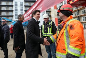 Canada’s Prime Minister Justin Trudeau meets workers as he tours new construction at Edgemont Flats housing complex during an announcement of new funding for housing in Edmonton, Alberta, Canada February 21, 2024.