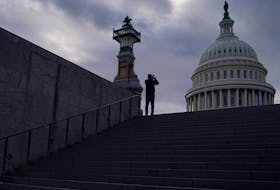 A man uses his mobile phone near the U.S. Capitol in Washington, U.S., January 10, 2024.