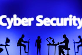 Figurines with computers and smartphones are seen in front of the words "Cyber Security" in this illustration taken, February 19, 2024.