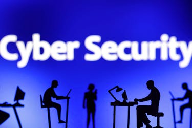 Figurines with computers and smartphones are seen in front of the words "Cyber Security" in this illustration taken, February 19, 2024.