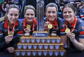 Team Ontario-Homan skip Rachel Homan, left to right, vice-skip Tracy Fleury, second Emma Miskew, lead Sarah Wilkes stand with the trophy after defeating Team Manitoba-Jones in the final at the Scotties Tournament of Hearts in Calgary on Sunday. 
