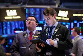 Traders work on the floor at the New York Stock Exchange (NYSE) in New York City, U.S., February 23, 2024. 