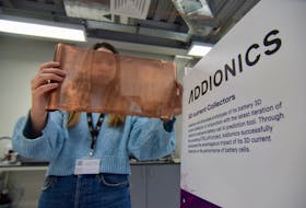 Bernadett Vejkey, marketing manager at Addionics, holds up a sheet of a porous, three-dimensional copper anode the battery materials startup has developed for electric vehicle batteries, at the company's lab in London, Britain, December 5, 2023.
