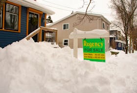 A for sale sign peeks out of the snow in front of a house in Halifax's West End on Monday, Feb. 5, 2024.
Ryan Taplin - The Chronicle Herald