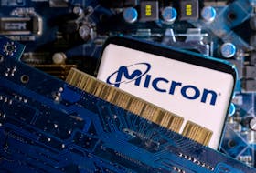 A smartphone with a displayed Micron logo is placed on a computer motherboard in this illustration taken March 6, 2023.