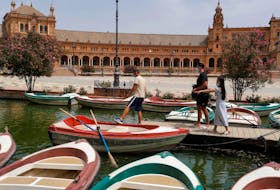 A boatman prepares a boat for tourists at the Plaza de Espana (Spain square), as a heatwave hits Spain, in Seville, southern Spain, August 13, 2021.
