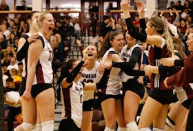 Saint Mary's Huskies players celebrate after defeating the Dalhousie Tigers to win their AUS women's volleyball semifinal series on Monday night at the Homburg Centre. - SMU Athletics
